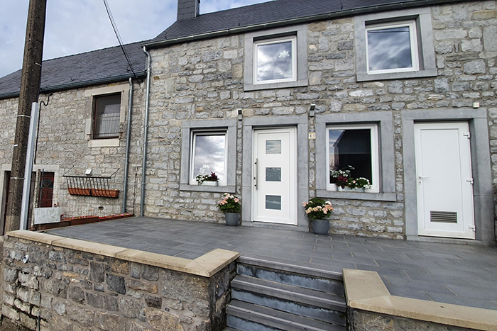 Une photo de la façade et de la terrasse avant